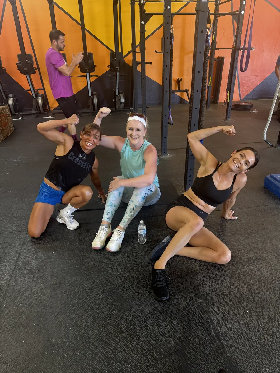 Three members celebrating together after a workout